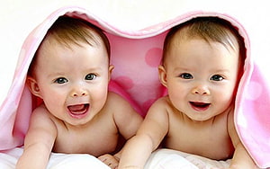 Smiling Twin Babies Under a Pink Polka Dot Blanket HD wallpaper