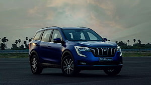 Mahindra XUV700 Blue SUV Parked on Open Road at Dusk HD wallpaper