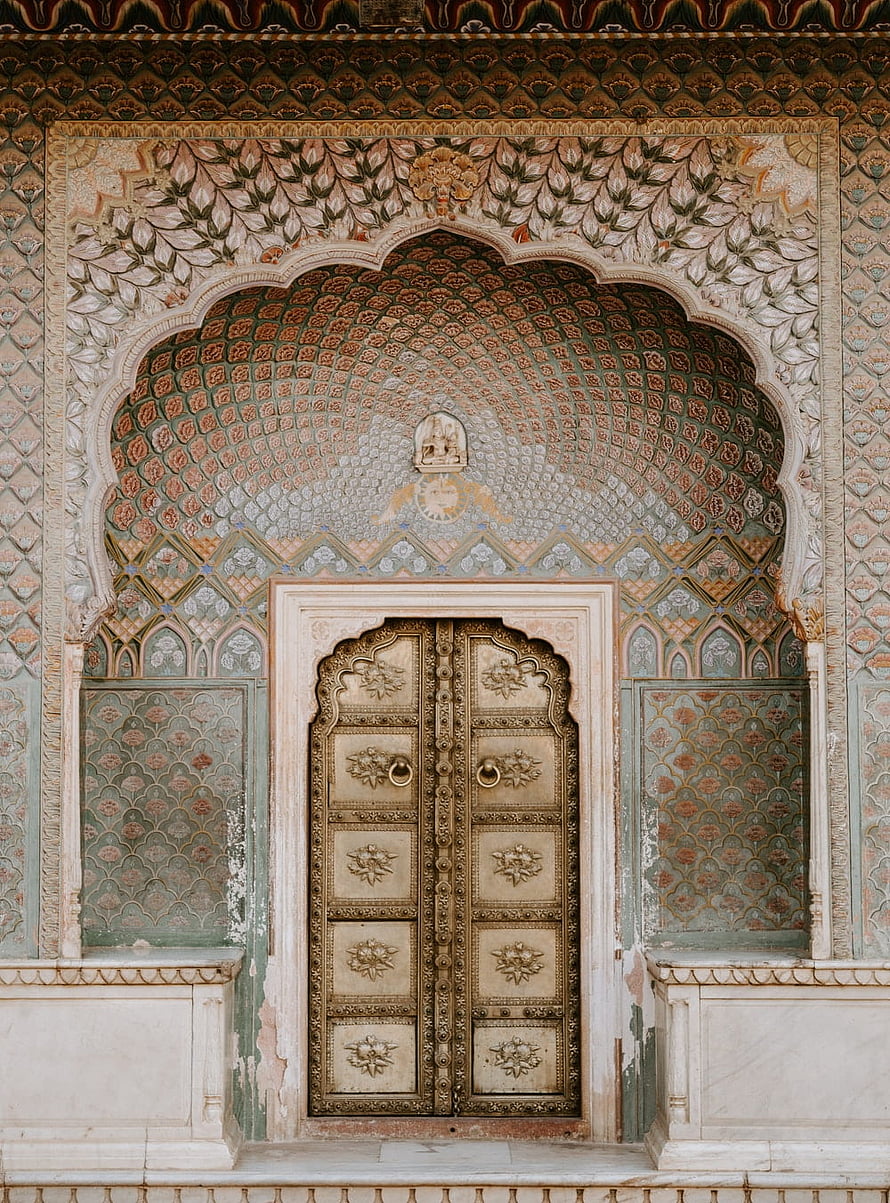 Ornate Mughal Archway with Intricate Floral Tilework and Carved Wooden Doors HD phone wallpaper