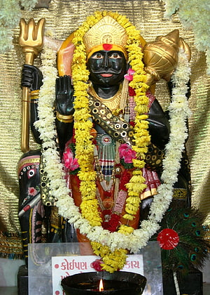 Shani Dev Murti Adorned With Marigold Garlands And Traditional Temple Decorations HD phone wallpaper