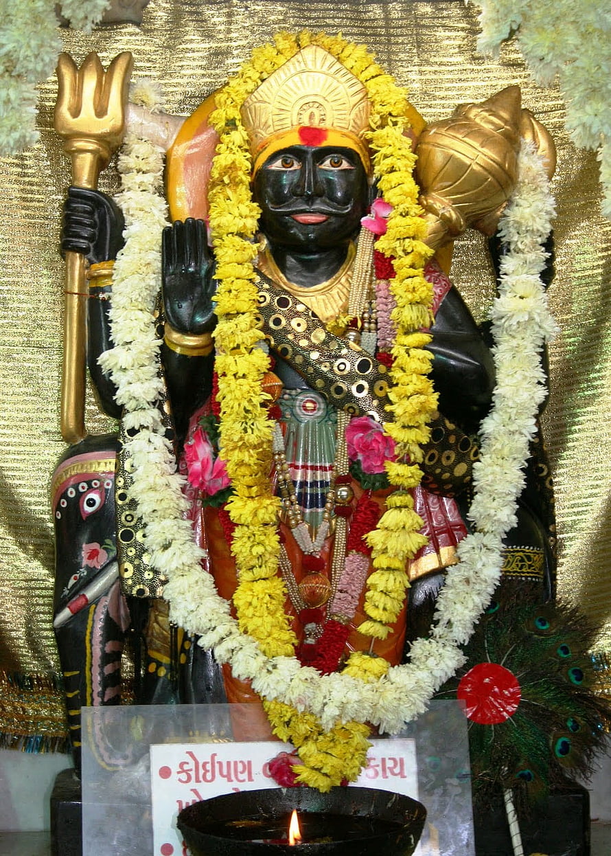 Shani Dev Murti Adorned With Marigold Garlands And Traditional Temple Decorations HD phone wallpaper