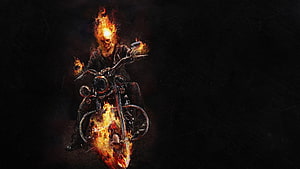 Ghost Rider on a flaming motorcycle with a burning skull against a dark background HD wallpaper