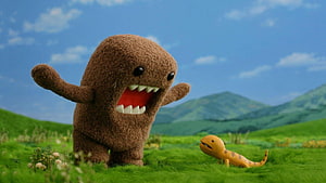 Furby and Domo Character in a Vibrant Green Meadow with Rolling Hills HD wallpaper