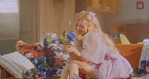 Rosé from Blackpink in a dreamy pastel room holding blue roses with a vintage yellow phone HD wallpaper