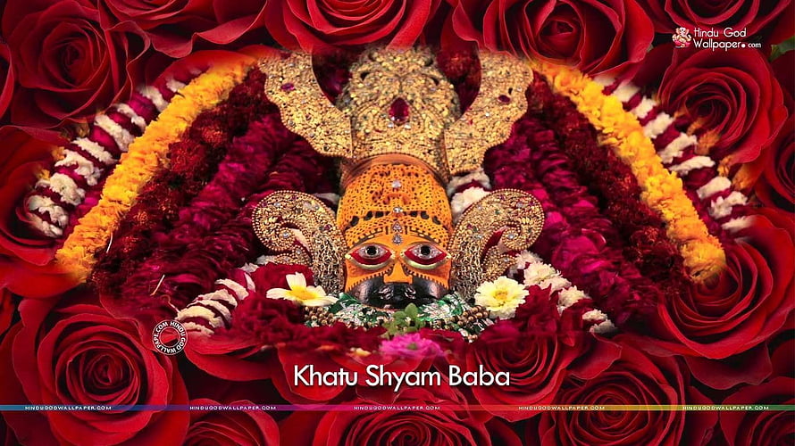 Khatu Shyam Baba adorned in vibrant red roses and golden floral garlands HD wallpaper