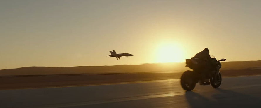 Top Gun Maverick motorcycle and fighter jet silhouette at golden sunset on desert runway HD wallpaper