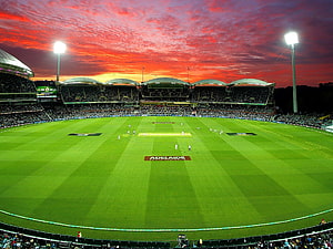 Adelaide Oval Cricket Ground Under Dramatic Red Sunset Sky HD wallpaper