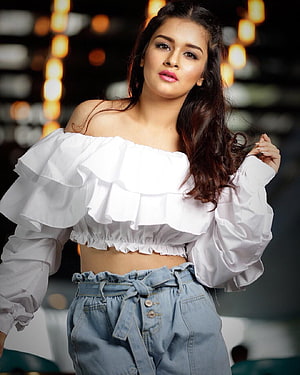 Avneet Kaur in White Off-Shoulder Ruffle Top and High-Waisted Denim Jeans HD phone wallpaper