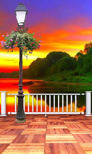 Vintage Street Lamp with Hanging Flowers on Wooden Deck at Sunset HD phone wallpaper
