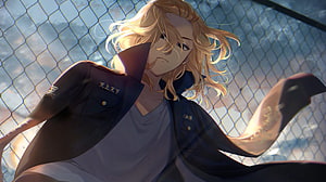 Mikey from Tokyo Revengers in a dark uniform against a chain-link fence with dramatic backlighting HD wallpaper