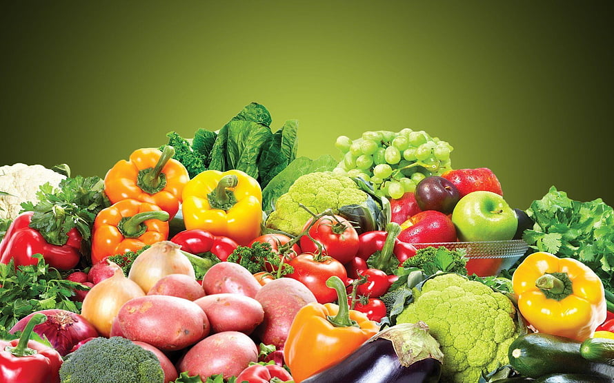 Vibrant assortment of fresh produce including peppers, tomatoes, potatoes, and leafy greens on a green background HD wallpaper