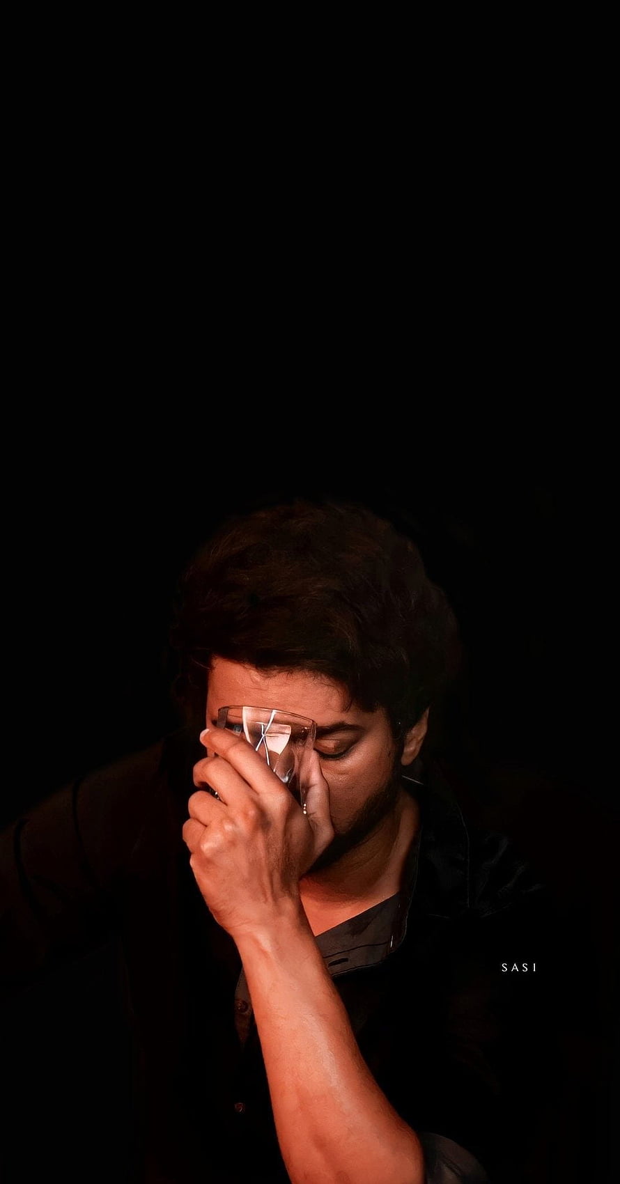 Ilayathalapathy Vijay in a moody portrait holding a glass against his face in dramatic low light HD phone wallpaper