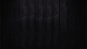 Dark Charcoal Wood Plank Texture with Subtle Vertical Grain and Minimalist Rustic Finish HD wallpaper