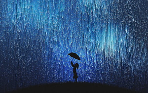 Silhouette of a person holding an umbrella under a heavy blue rainstorm HD wallpaper