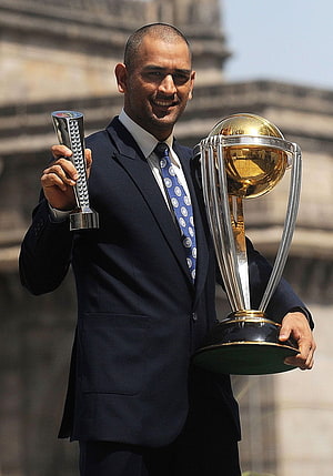 MS Dhoni Holding Cricket World Cup Trophy and Player of the Tournament Award HD phone wallpaper