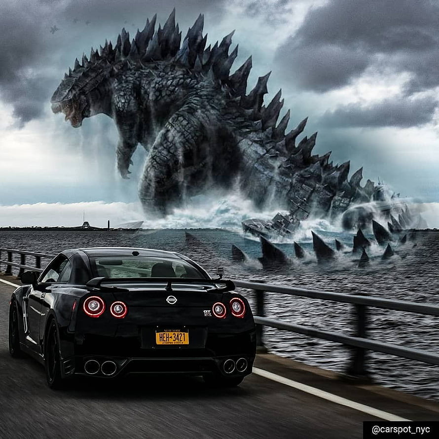 Black Nissan GT-R on Coastal Highway with Godzilla Rising from the Sea HD phone wallpaper
