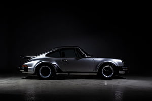 Silver Porsche 930 Turbo Side Profile in Dramatic Studio Lighting HD wallpaper