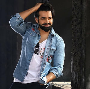 Ram Pothineni in a casual denim shirt and white t-shirt with a confident smile HD wallpaper