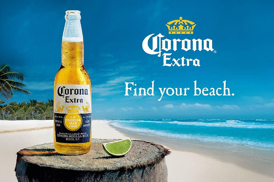Corona Extra beer bottle with lime wedge on a tropical beach with turquoise ocean and palm trees HD wallpaper
