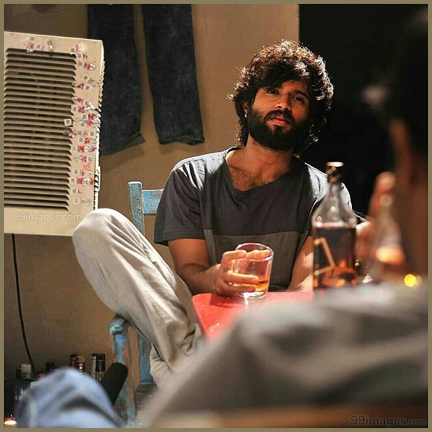 Vijay Deverakonda as Arjun Reddy in a moody indoor scene with a drink HD phone wallpaper