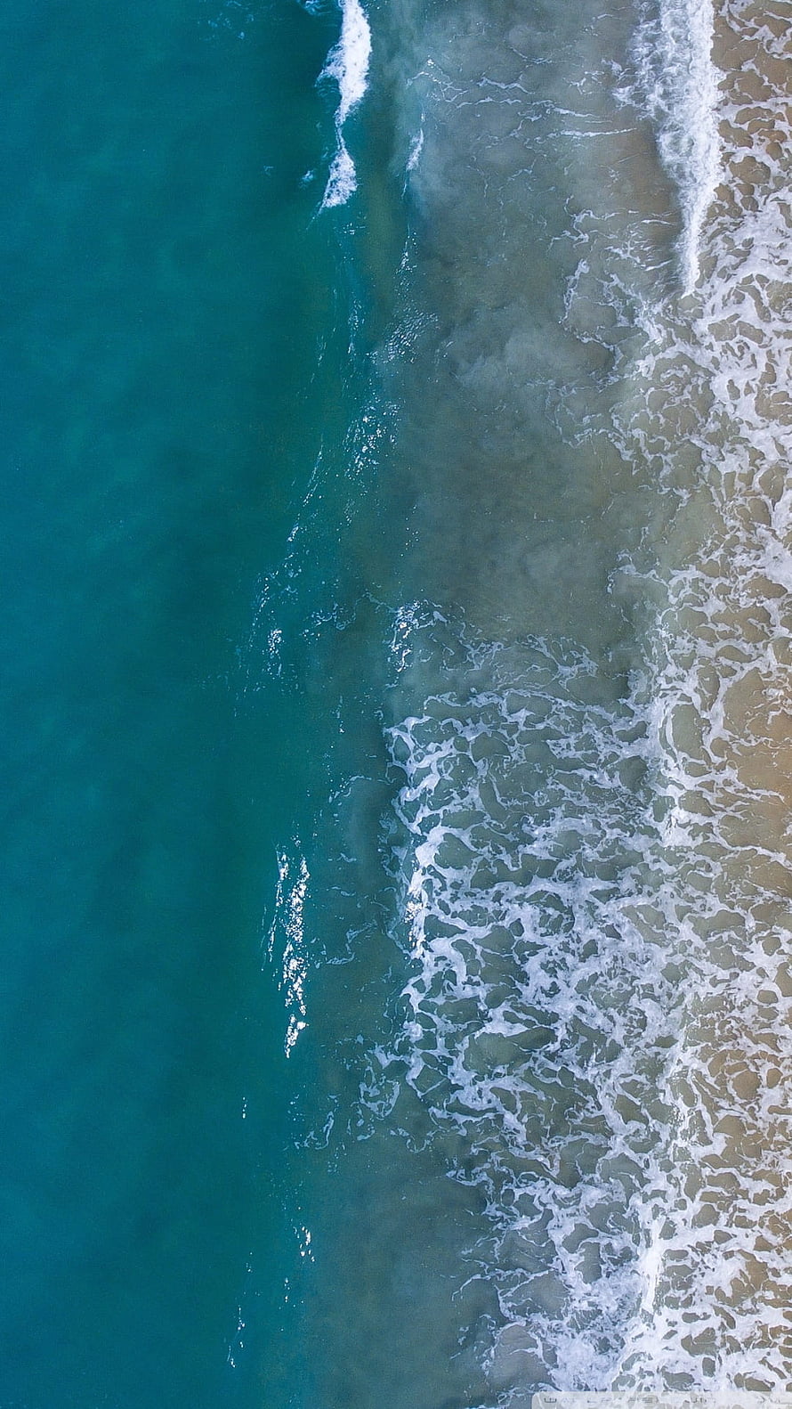 Aerial View of Turquoise Ocean Waves Rolling onto a Sandy Shore HD phone wallpaper