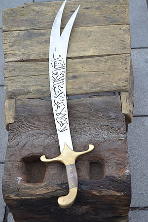 Handcrafted Turkish Zulfiqar Sword with Arabic Calligraphy on Weathered Wood HD phone wallpaper