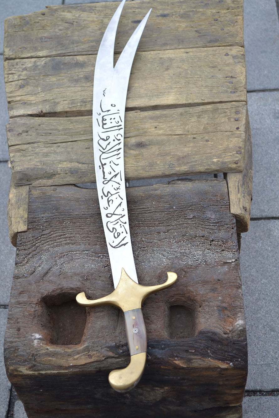 Handcrafted Turkish Zulfiqar Sword with Arabic Calligraphy on Weathered Wood HD phone wallpaper