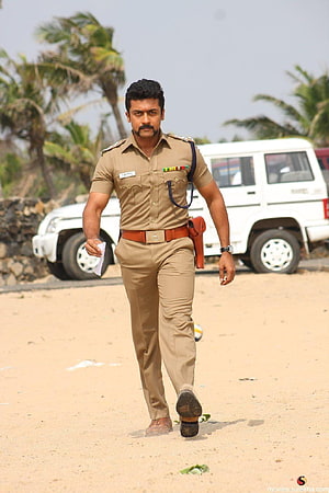 Surya in Police Uniform Walking on Beach with White SUV and Palm Trees HD phone wallpaper