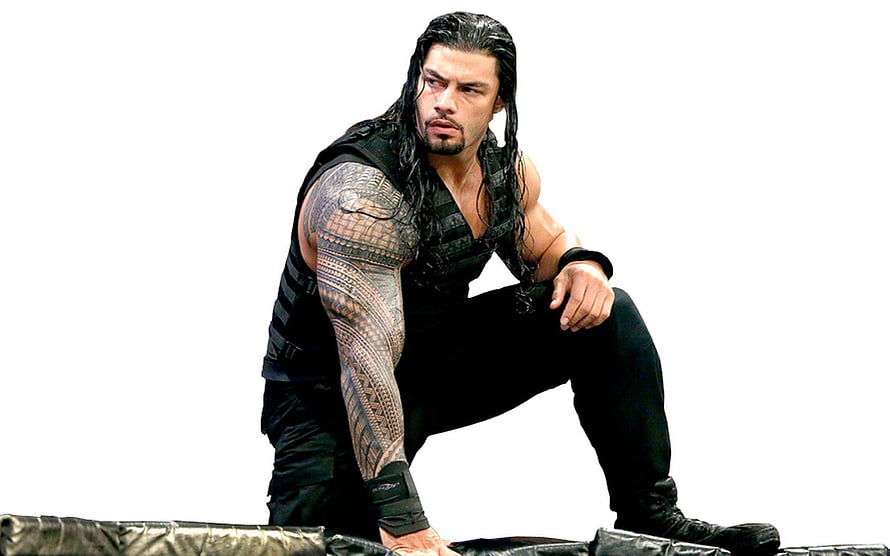 Roman Reigns in Black Tactical Gear Crouching on Wrestling Ring Apron HD wallpaper