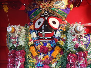 Jagannath Deity Adorned With Vibrant Flower Garlands And Ornate Crown HD wallpaper
