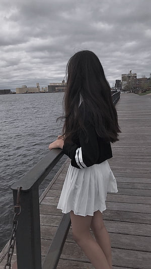Korean Ulzzang Girl in Black Jacket and White Pleated Skirt on a Lakeside Boardwalk HD phone wallpaper