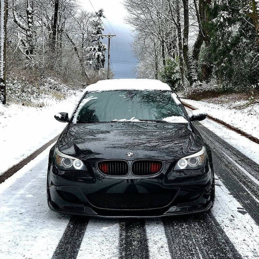Black BMW M5 E60 Sedan Parked on Snowy Forest Road in Winter HD phone wallpaper