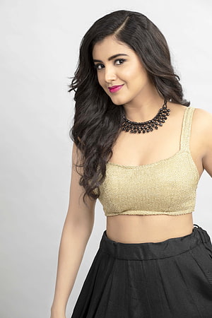 Malavika Sharma in Gold Crop Top and Black Skirt with Beaded Necklace HD phone wallpaper