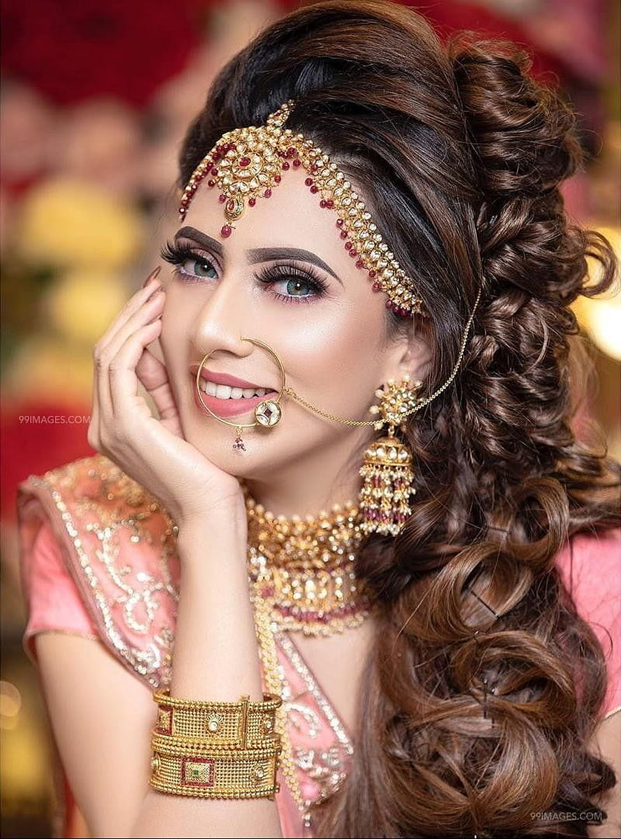 Elegant Indian Bride in Traditional Pink Lehenga with Gold Jewelry and Intricate Bridal Makeup HD phone wallpaper