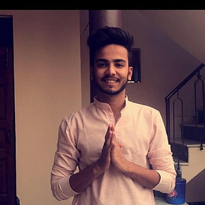 Elvish Yadav smiling warmly in a light kurta with hands pressed together in a greeting gesture HD phone wallpaper
