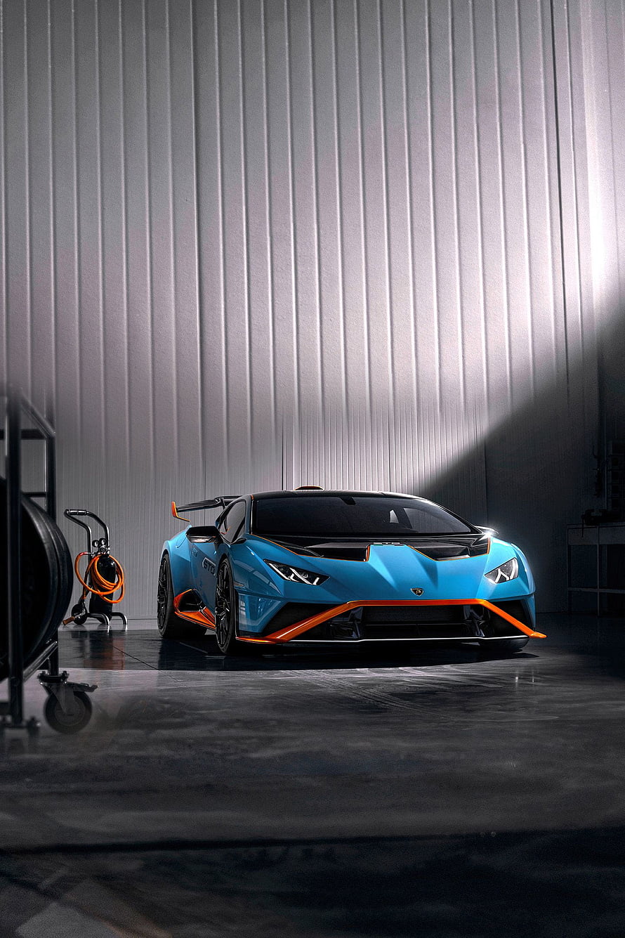 Lamborghini Huracan STO in Blue and Orange Parked in a Modern Industrial Garage HD phone wallpaper
