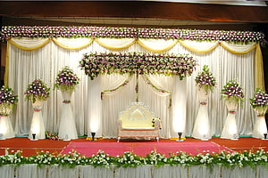 Elegant Indian Wedding Stage with Floral Drapes and Ornate Seating HD wallpaper