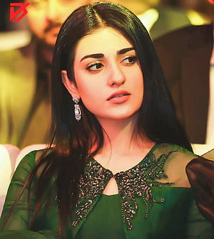 Sarah Khan in an elegant emerald green embroidered outfit with detailed beadwork and ornate earrings HD phone wallpaper