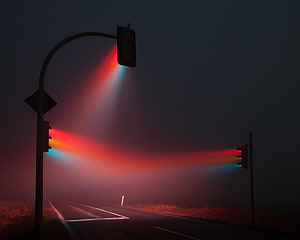 Misty Night Roadway with Glowing Traffic Signals and Atmospheric Light Beams HD wallpaper