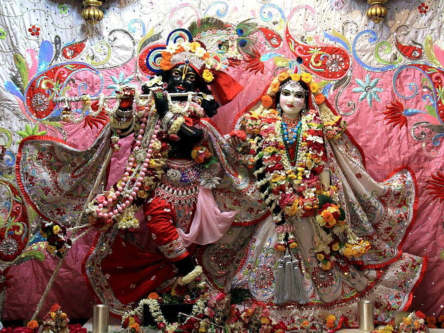 Krishna and Radha Rani ornate temple deities adorned with flowers and jewelry HD wallpaper