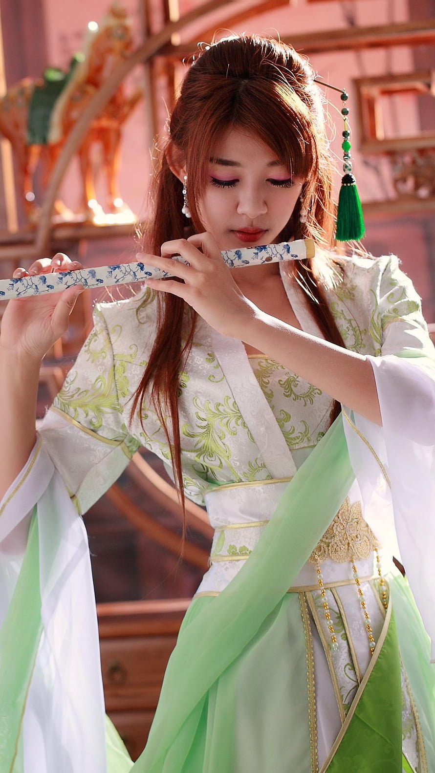 Elegant Woman in Traditional Hanfu Playing a Decorated Chinese Flute HD phone wallpaper