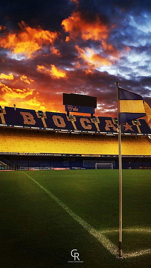 La Bombonera Stadium at Sunset with Dramatic Orange Clouds and Boca Juniors Seating HD phone wallpaper