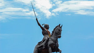 Chhatrapati Shivaji Maharaj Equestrian Statue with Raised Sword Against Blue Sky HD wallpaper