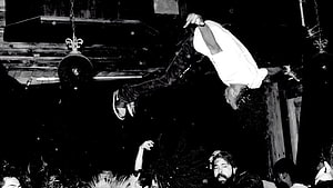 Playboi Carti performing an acrobatic flip over the crowd at a live concert HD wallpaper
