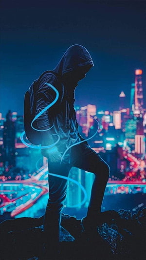 Hacker in Hoodie with Glowing Blue Energy Over Neon City Skyline at Night HD phone wallpaper