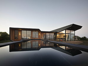 Contemporary Wood and Glass Residence with Infinity Pool at Dusk HD wallpaper