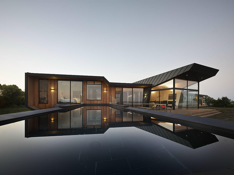 Contemporary Wood and Glass Residence with Infinity Pool at Dusk HD wallpaper