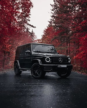 Black Brabus G63 AMG SUV on a Wet Forest Road with Red Autumn Foliage HD phone wallpaper