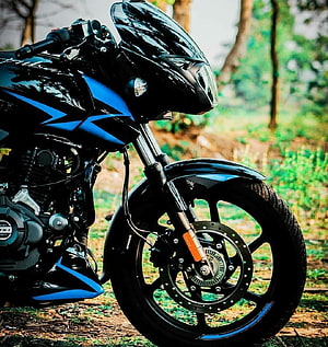 Black and Blue Bajaj Pulsar 150 Motorcycle Front View in Forest Setting HD phone wallpaper