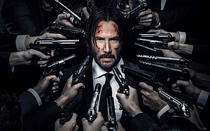 John Wick Surrounded by Guns in Dark Suit with Bloodied Face HD wallpaper